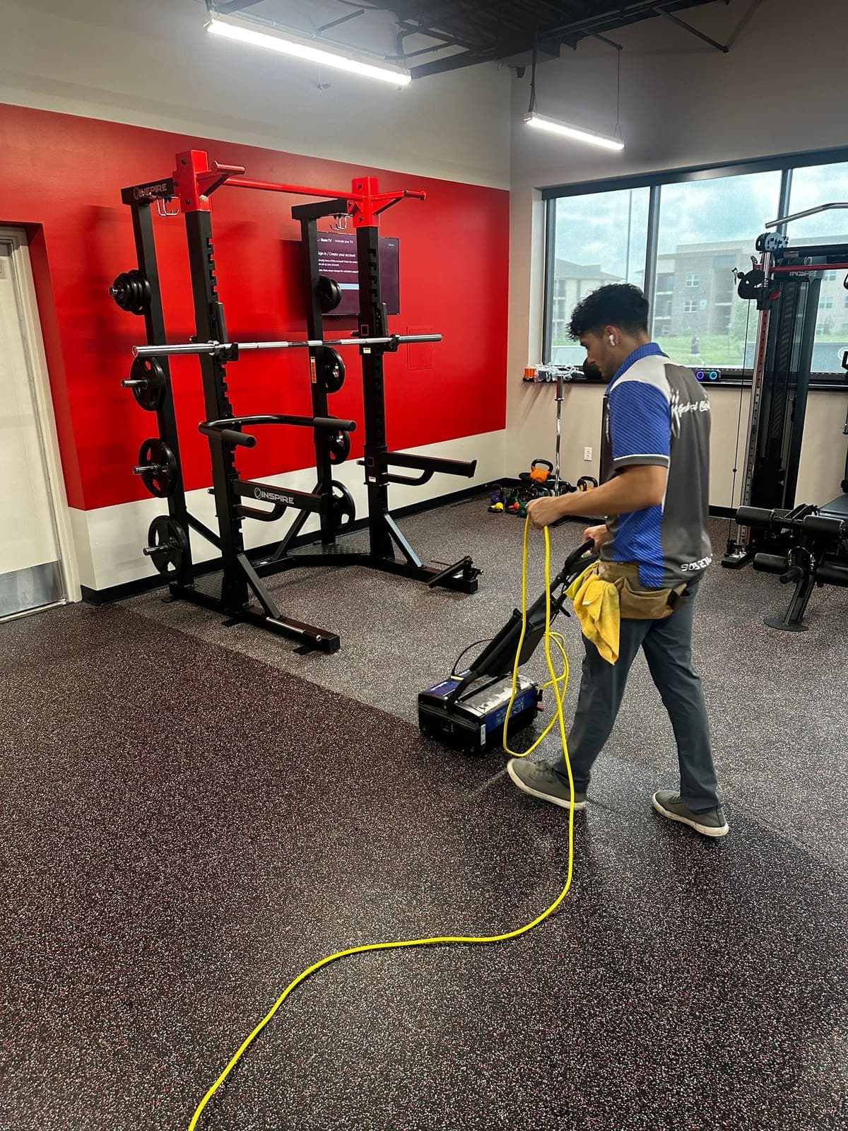 Crew member detailing gym equipment