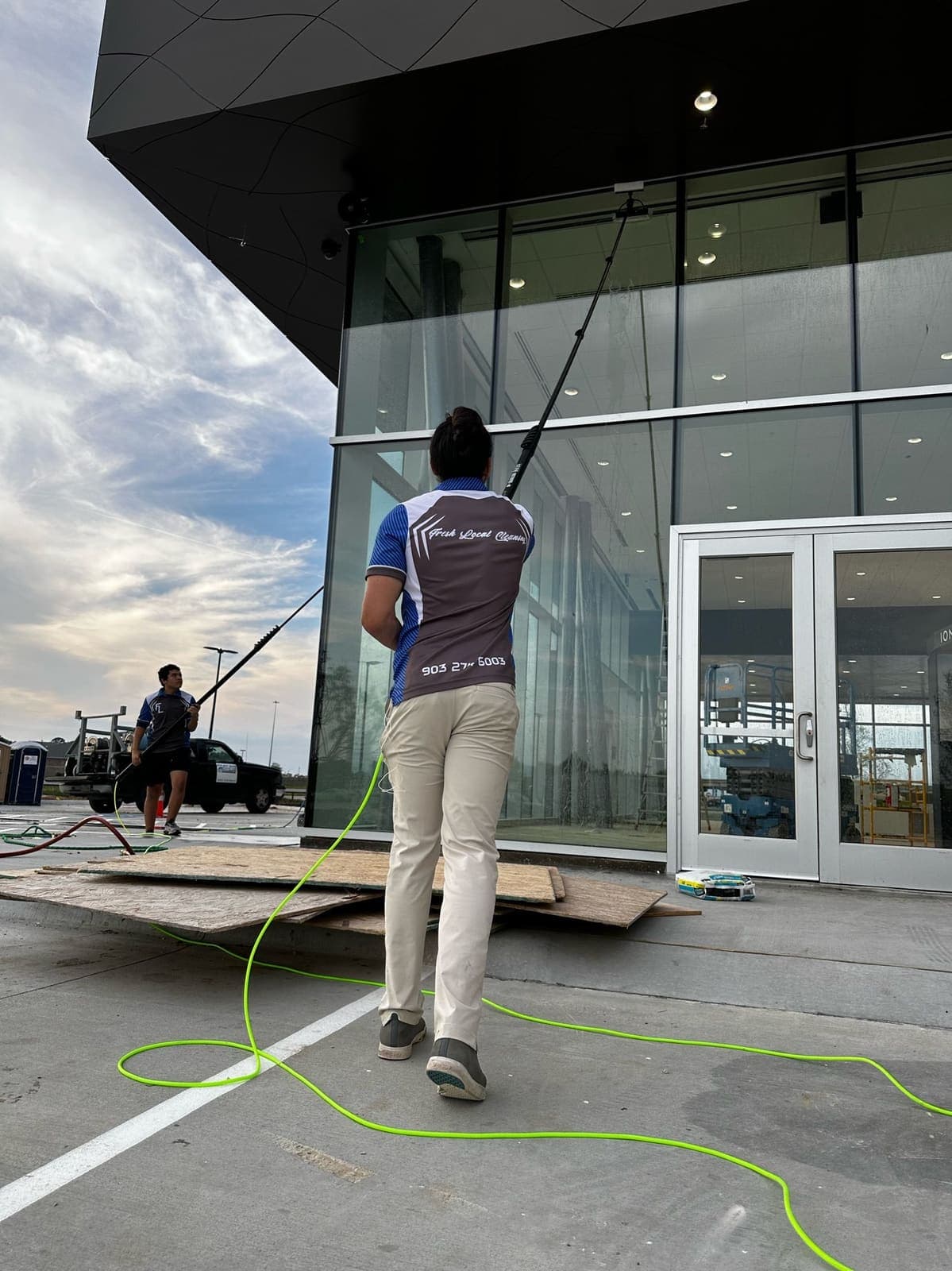 BLU crew water-fed-pole cleaning glass on a new commercial build