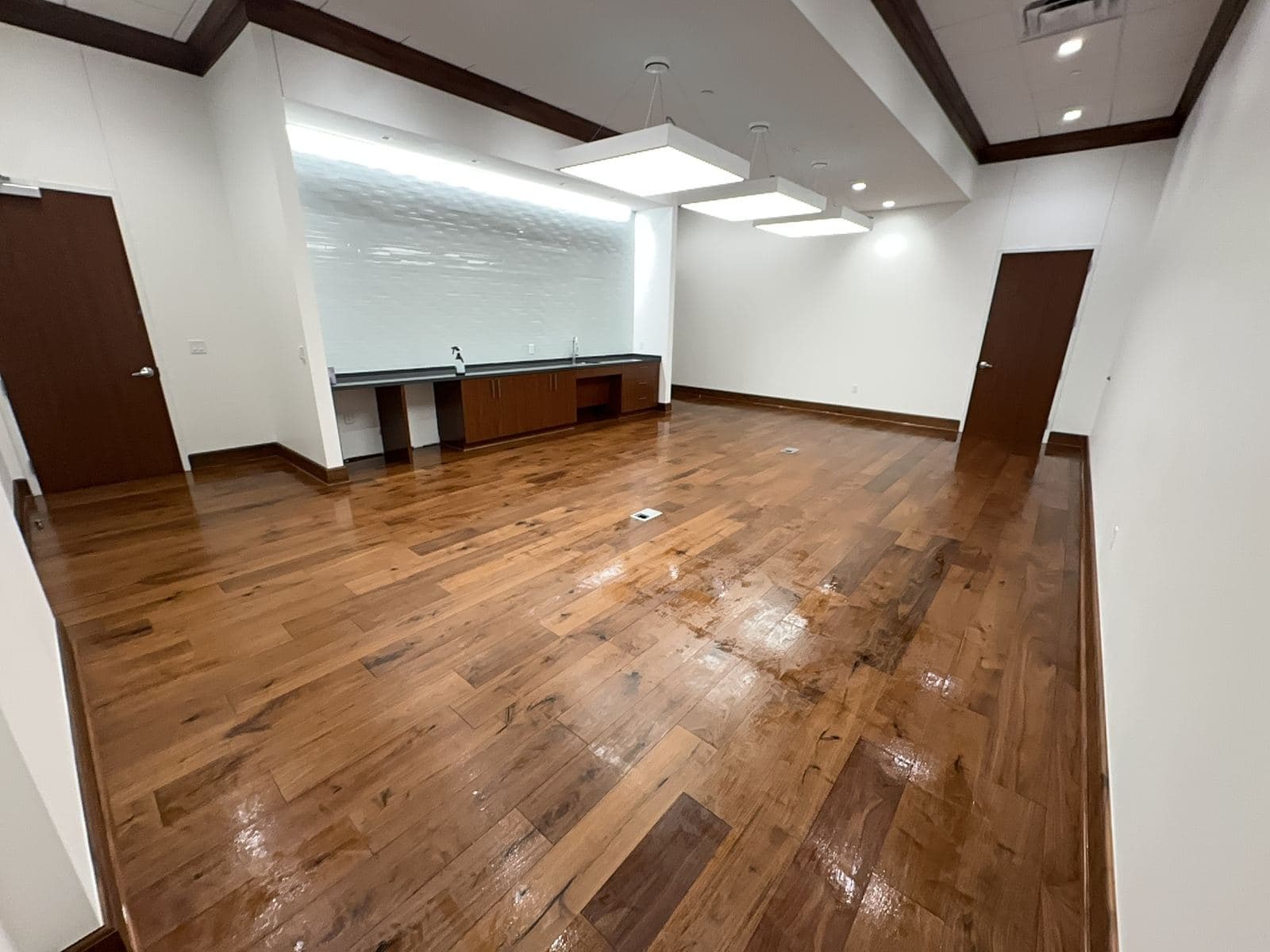 Executive conference room with rich hardwood floor after final clean