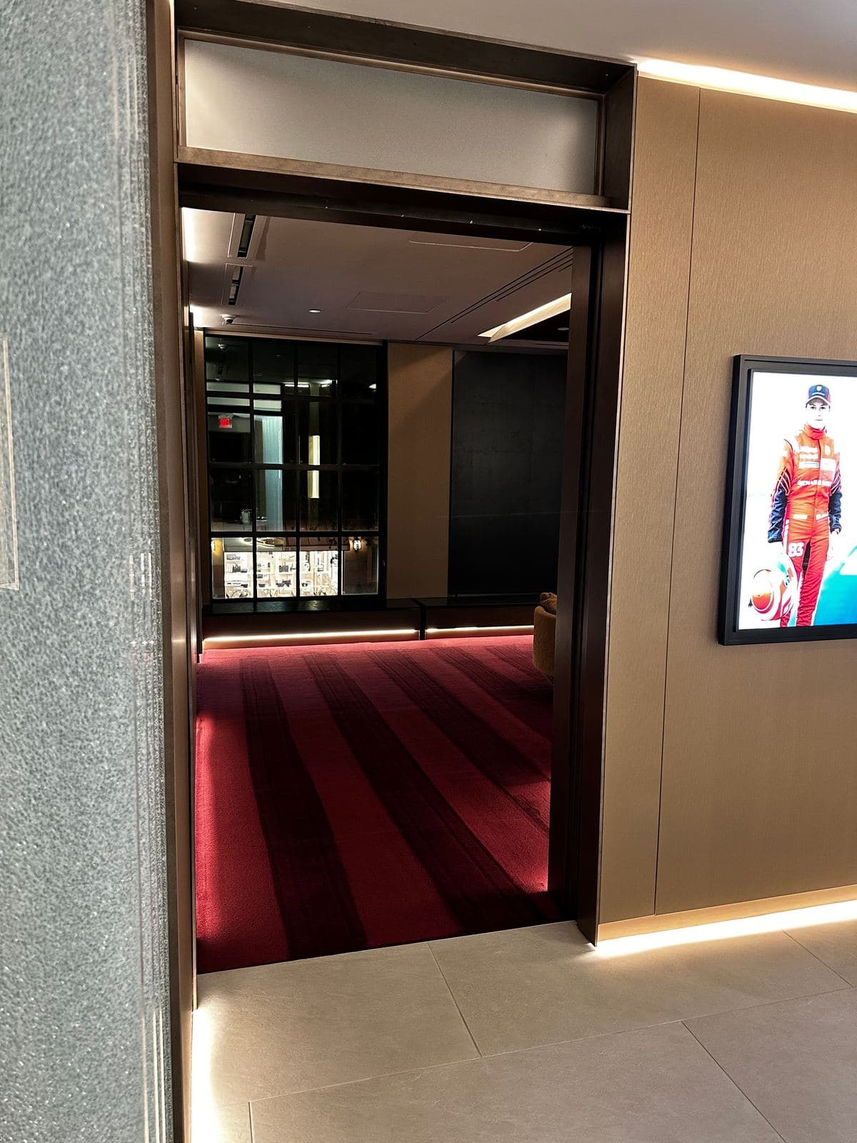 Richard Mille boutique entry with red carpeted wall, detailed for opening