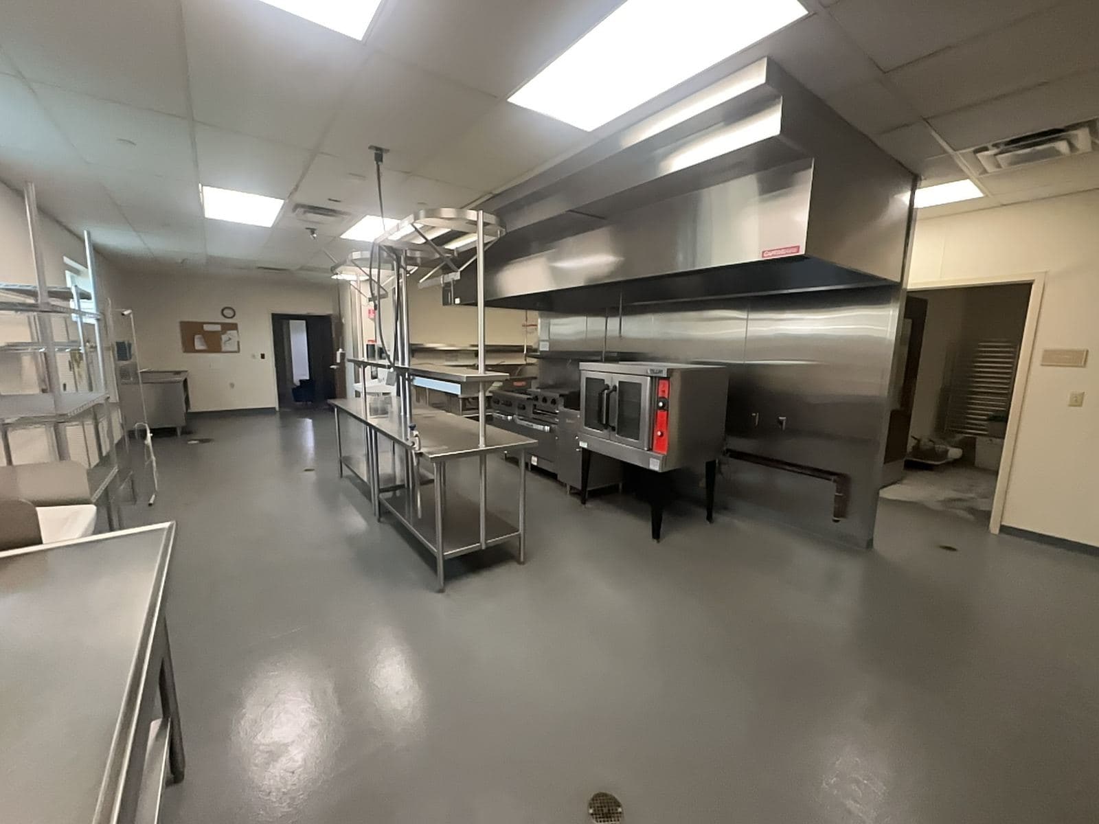 Commercial stainless kitchen in a rehab hospital, cleaned for handoff